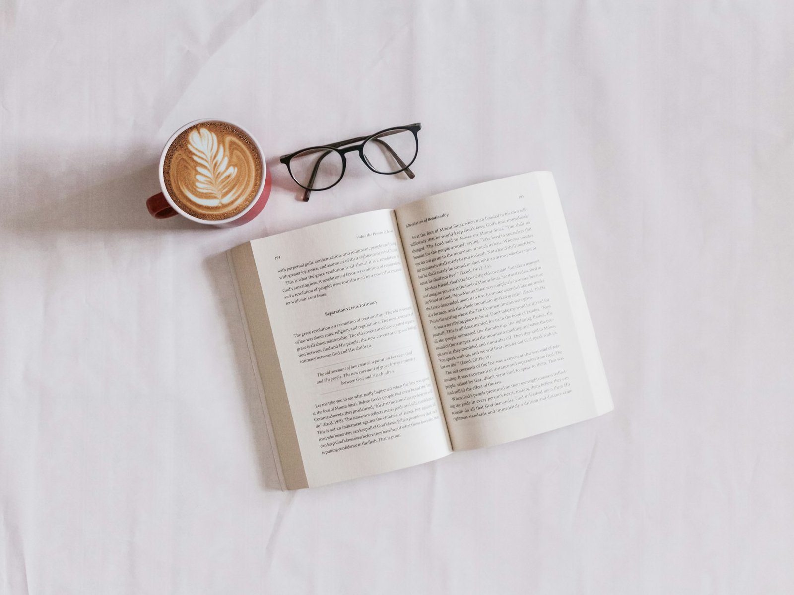Open book, coffee and glasses